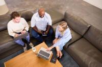 Full-Color-Group-of-People-Talking-on-Couch-With-Laptop Size Optimized